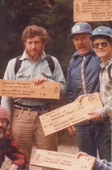 laughing men with wood signs