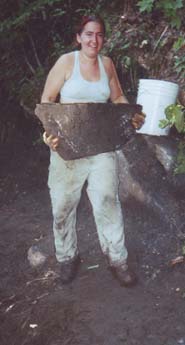 woman lifting large rock